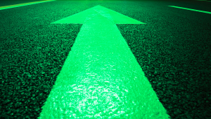 Green arrow in road pointing forward