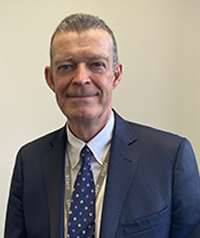 Head and shoulders shot of Jim Taylor in suit, smiling